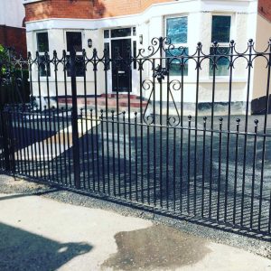 Black steel driveway gate and fence